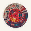 Ancient Lore Morganite handmade woven wicker wall basket with a red radial center, purple, teal blue, beige, and yellow geometric bands.