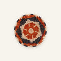 Cinder woven wicker wall basket with concentric orange, black, and beige rings