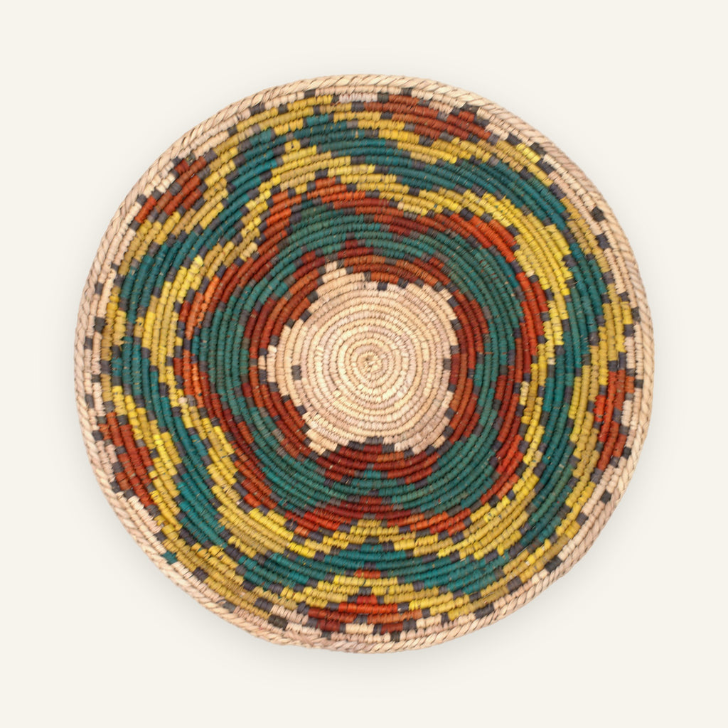 Colorblast Nature woven wicker wall basket with concentric green, yellow, orange, gray, and natural beige rings.