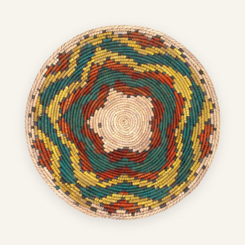 Colorblast Nature woven wicker wall basket with concentric green, yellow, orange, gray, and natural beige rings.