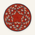 Ethnicity handmade woven wicker wall basket with red, beige, and black geometric patterns in concentric rings.
