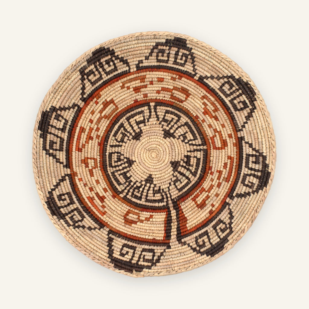 Flora woven wicker wall basket with concentric geometric bands in beige, black, and orange-brown
