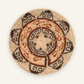 Flora woven wicker wall basket with concentric geometric bands in beige, black, and orange-brown