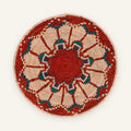 Fluorescence Ruby woven wicker wall basket with a red spiral center, beige geometric rays, teal blue and purple accents, and a red outer border.