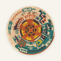 Jungle Lore Rustic handmade woven wicker wall basket with a terracotta, teal, yellow, purple, and natural beige geometric circular pattern.