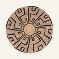 Mirage woven wicker wall basket in natural beige with a black radiating geometric pattern