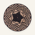 Nightfall woven wicker wall basket with a black center and irregular beige geometric bands.