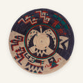 Oceanic Lore Deep woven wicker wall basket with a circular geometric pattern in deep blue, beige, red, and green