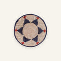Ritual handmade woven wicker wall basket in beige with deep blue circular bands and red accent details
