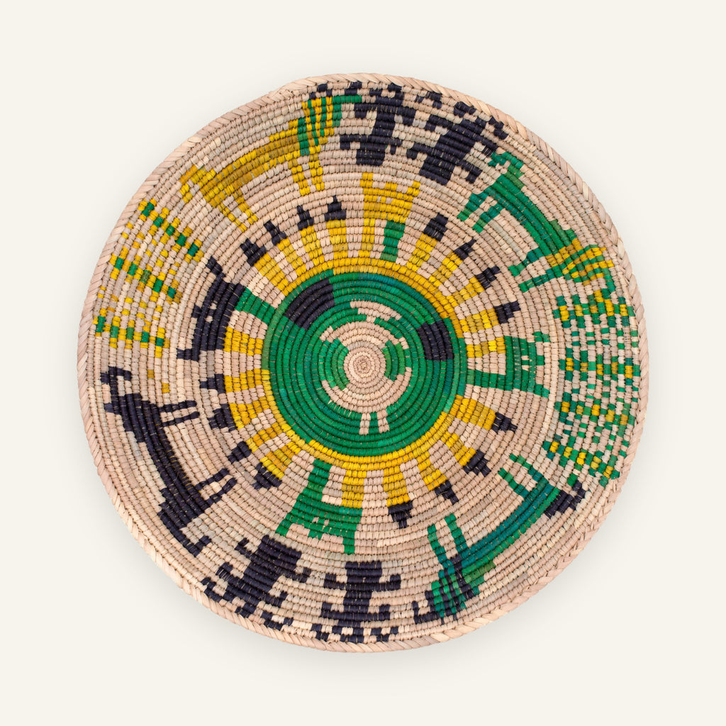 Sacrifice Moss woven wicker wall basket with a green spiral center and yellow, black, and beige geometric pattern