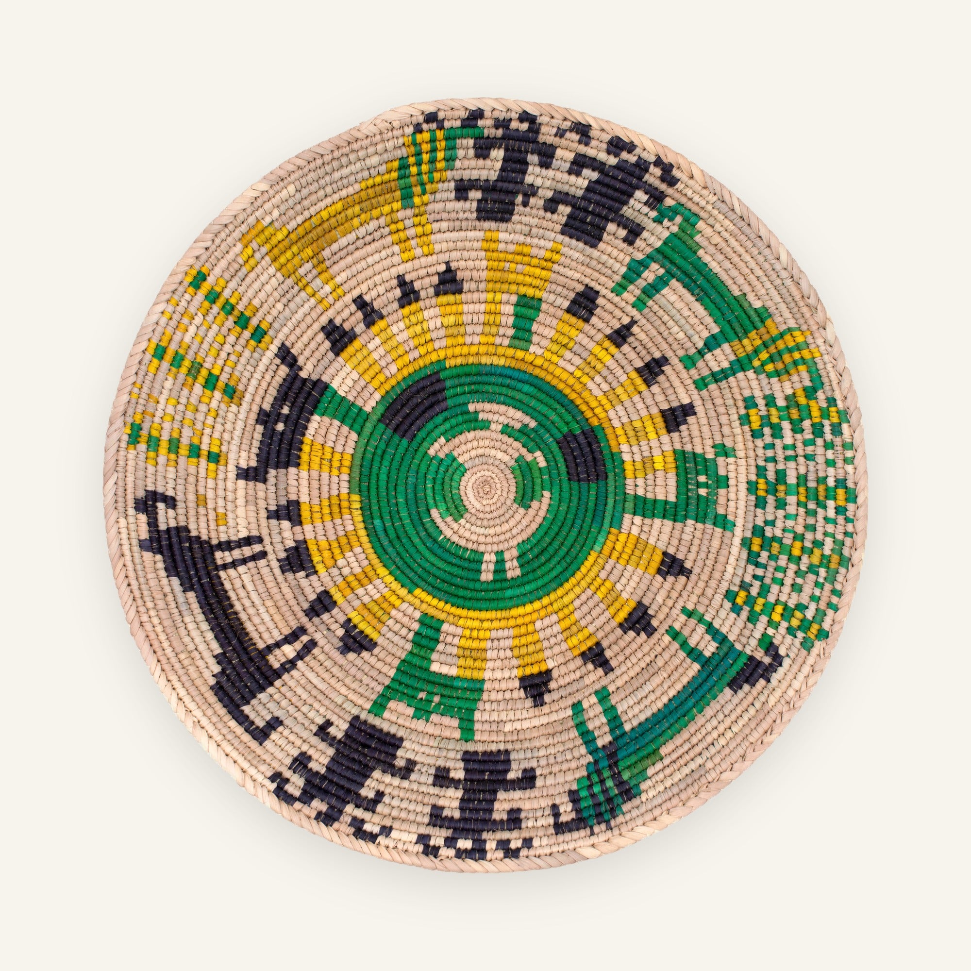 Sacrifice Moss woven wicker wall basket with a green spiral center and yellow, black, and beige geometric pattern