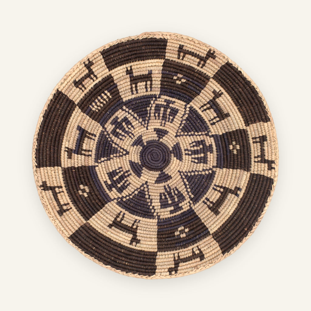 Society Distinct woven wicker wall basket with a dark brown and beige concentric geometric pattern