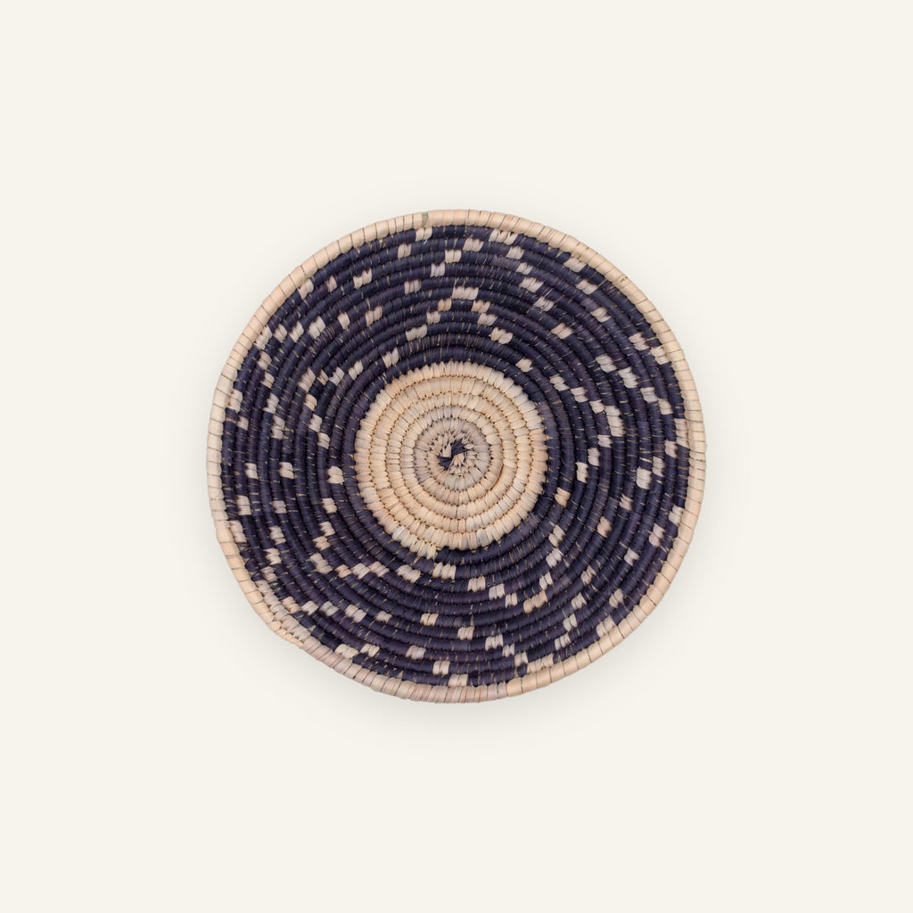 Starry Moment mini woven wicker wall basket with a beige spiral center, dark concentric rings, and scattered light geometric accents.