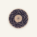 Starry Moment mini woven wicker wall basket with a beige spiral center, dark concentric rings, and scattered light geometric accents.