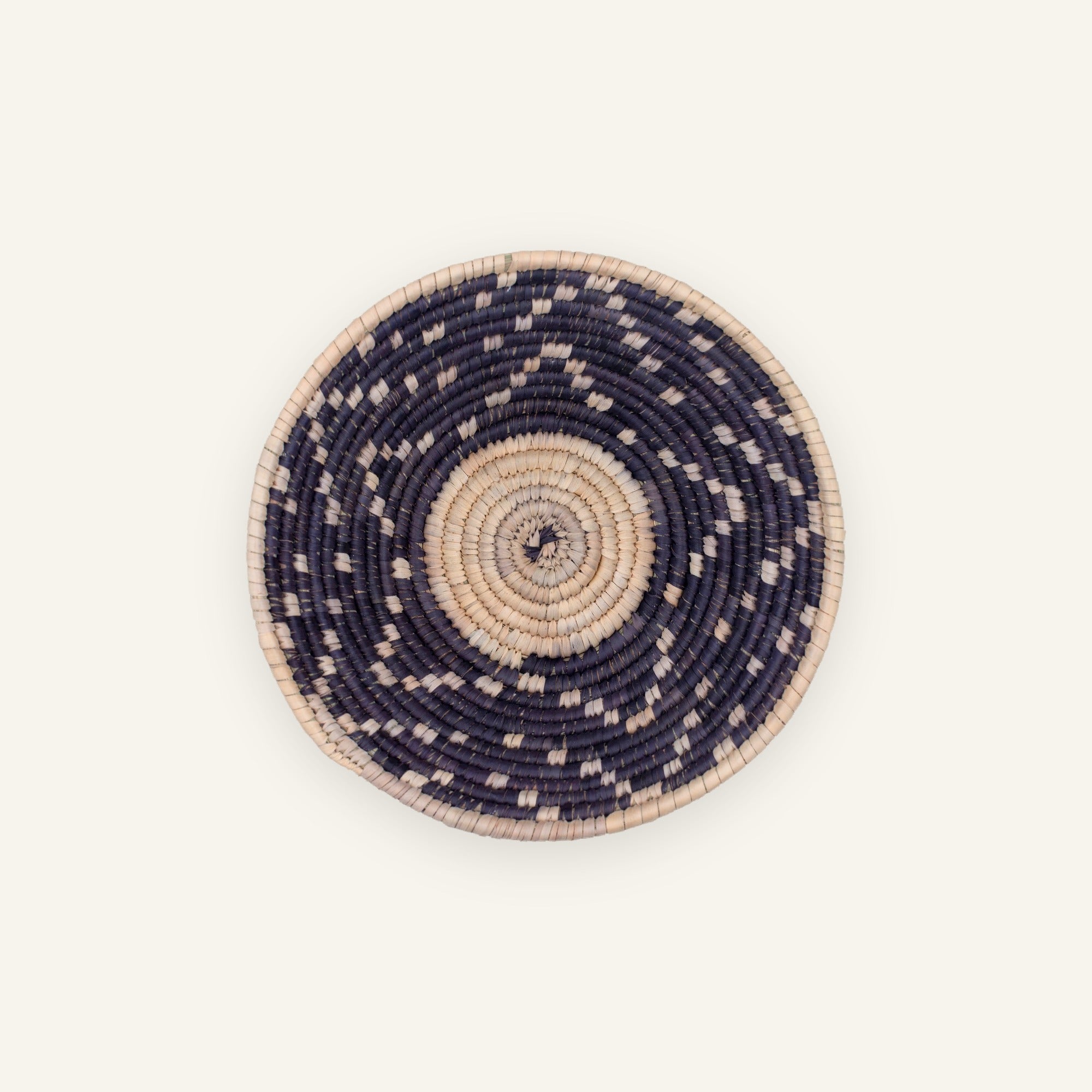 Starry Moment mini woven wicker wall basket with a beige spiral center, dark concentric rings, and scattered light geometric accents.