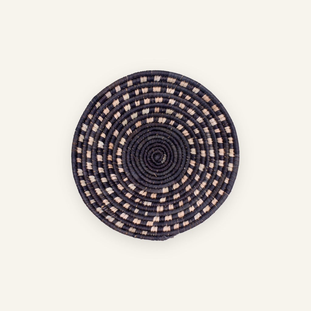 Stellar mini woven wicker wall basket with black concentric coils and beige dashed circular pattern.