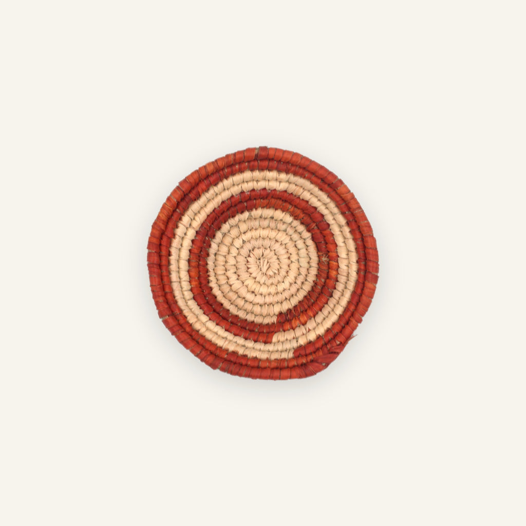 Sunring Orange mini woven wicker wall basket with concentric terracotta-red and natural beige rings.