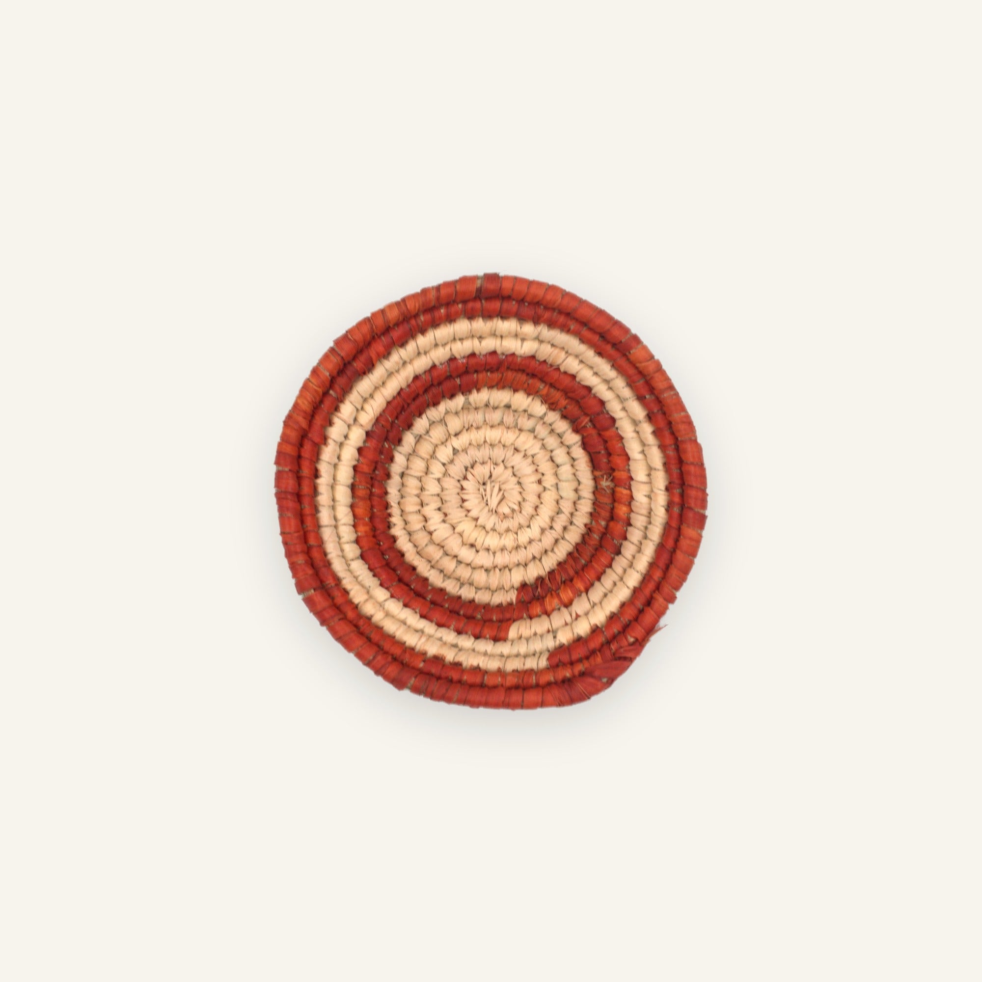 Sunring Orange mini woven wicker wall basket with concentric terracotta-red and natural beige rings.