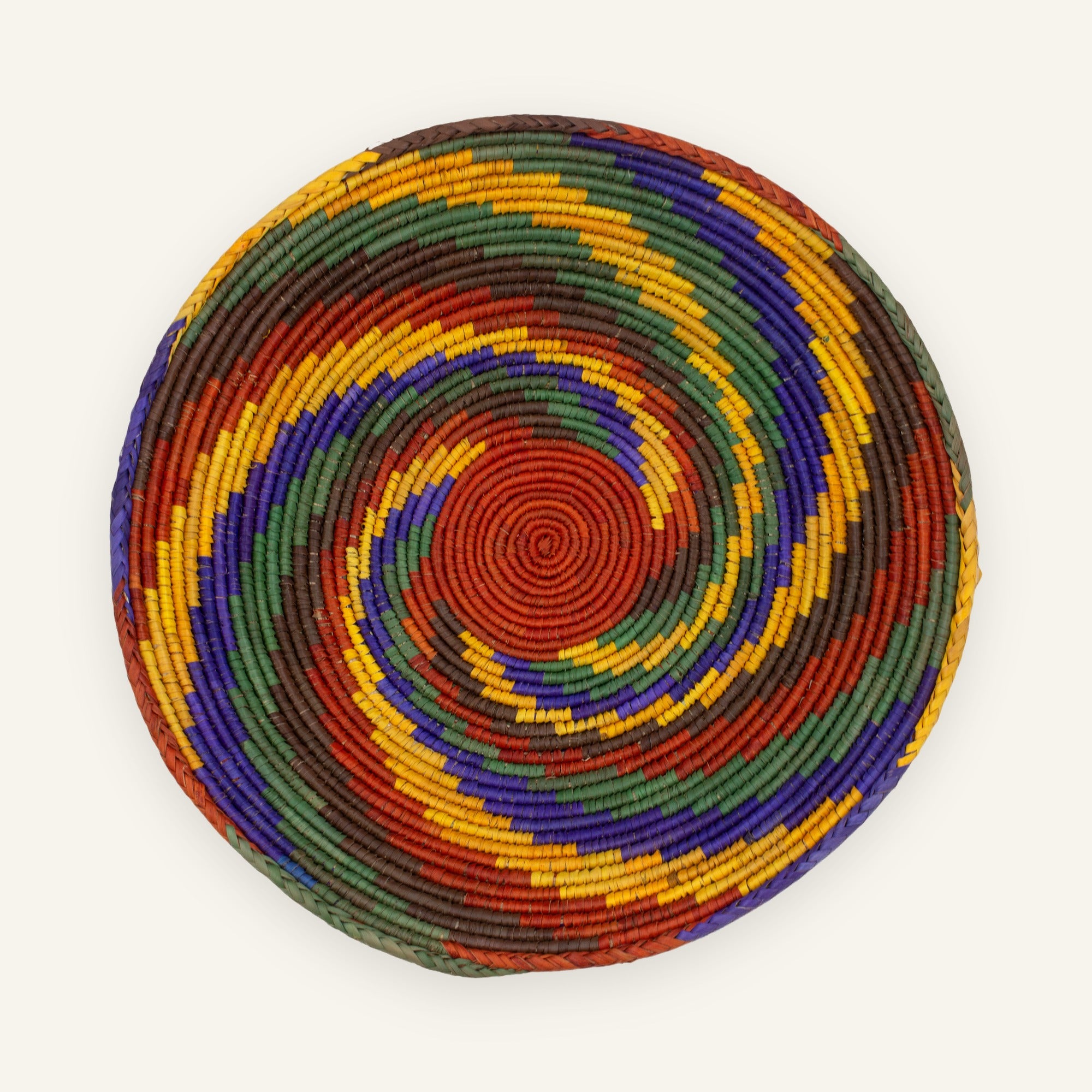 Whirlpool Origin handmade woven wicker wall basket with a red center and concentric green, purple, yellow, and brown rings